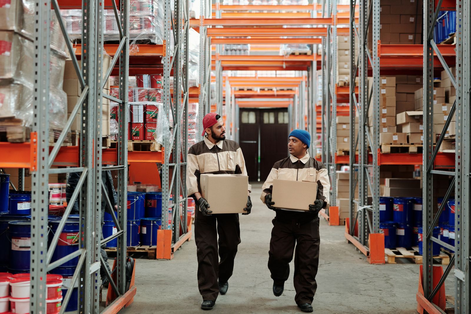 Workers handling pharmaceutical supply boxes in a distribution warehouse in Ethiopia