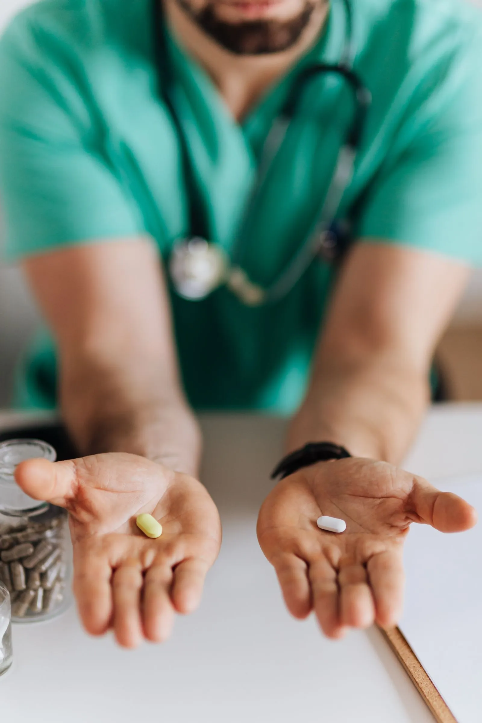 Antimalarial tablets held in a gloved hand, part of a hospital's rainy-season malaria stock