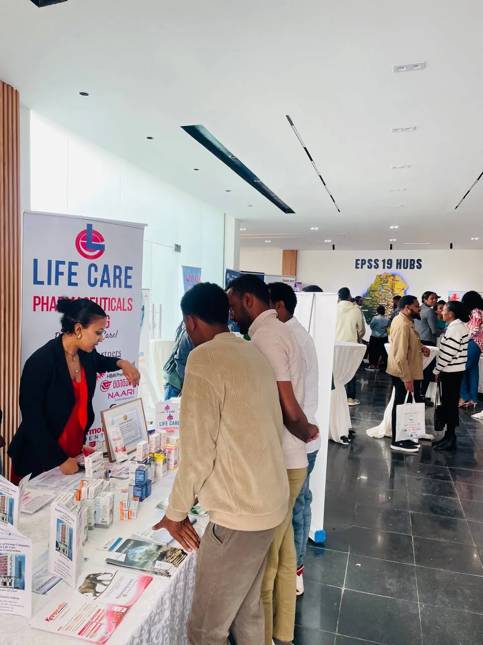 The LifeCare stand at the 46th EPA Annual Scientific Conference Visitors at the LifeCare Pharmaceuticals Trading exhibition stand with the EPSS 19 Hubs map display behind them