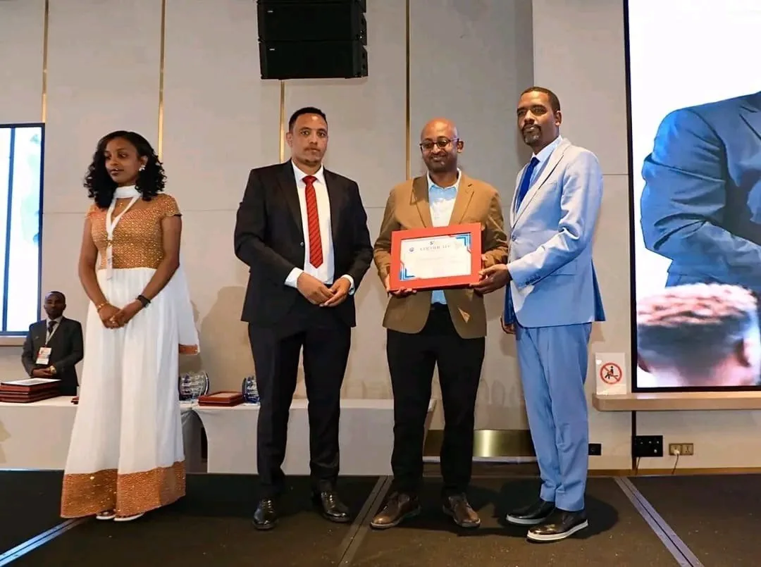 LifeCare representative receiving a framed certificate of recognition on stage at the 5th EPSS International Suppliers Conference